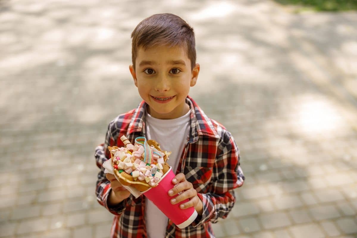 Child enjoying holiday treats while wearing braces in Roseville, CA.