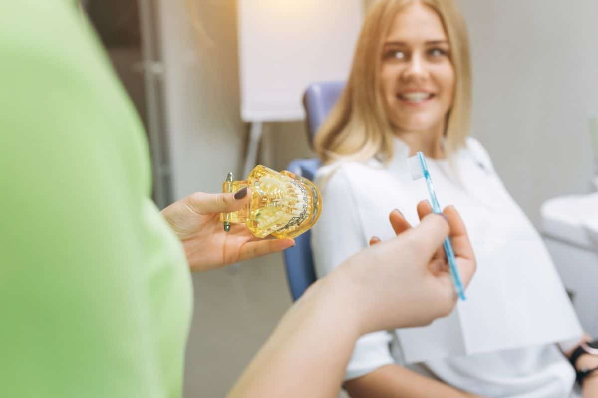 Orthodontist consulting with a patient in a modern dental office.