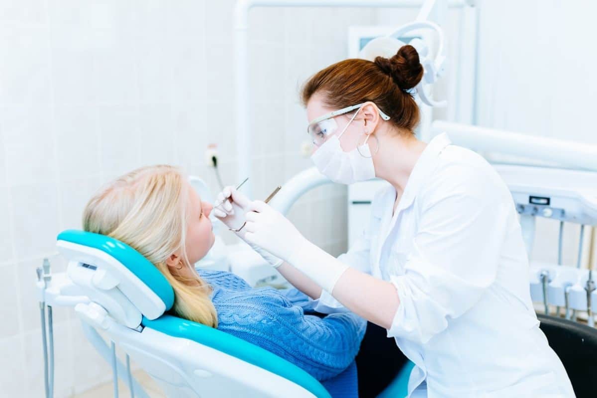 Orthodontist in Roseville, CA, examining a patient during their first visit.